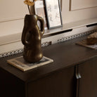A modern four-door sideboard cabinet in dark brown wood with slim vertical handles.
